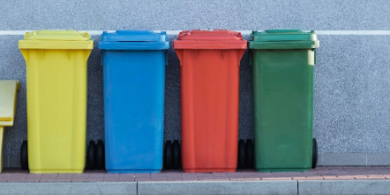 A picture of four trash bins that has been color coded