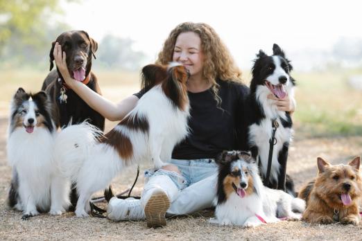 A picture of a woman having fun with dogs